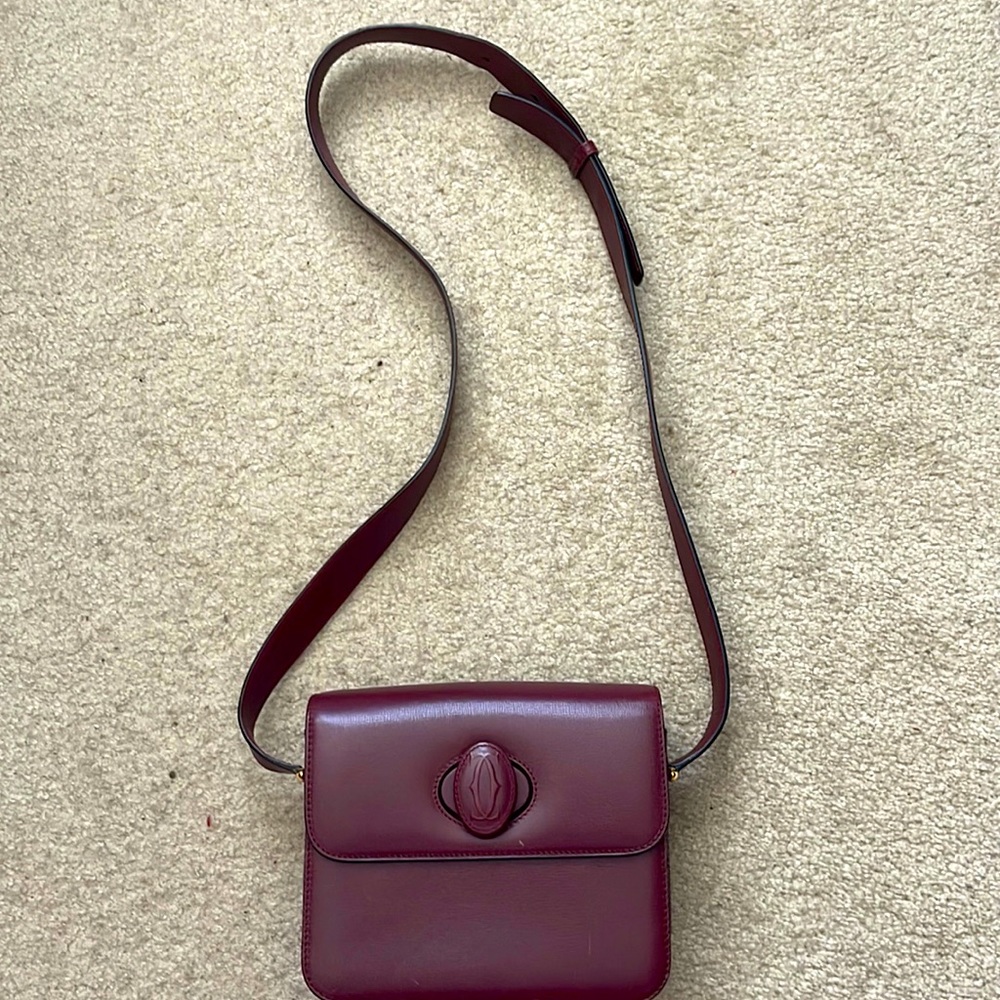 Used, in good condition purse by Cartier. Strap,It’s 115 inches long .It’s Chic